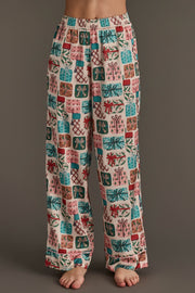 Wide-leg Christmas Presents Satin Pajama Set pants featuring a colorful pattern of festive holiday presents and ribbons.