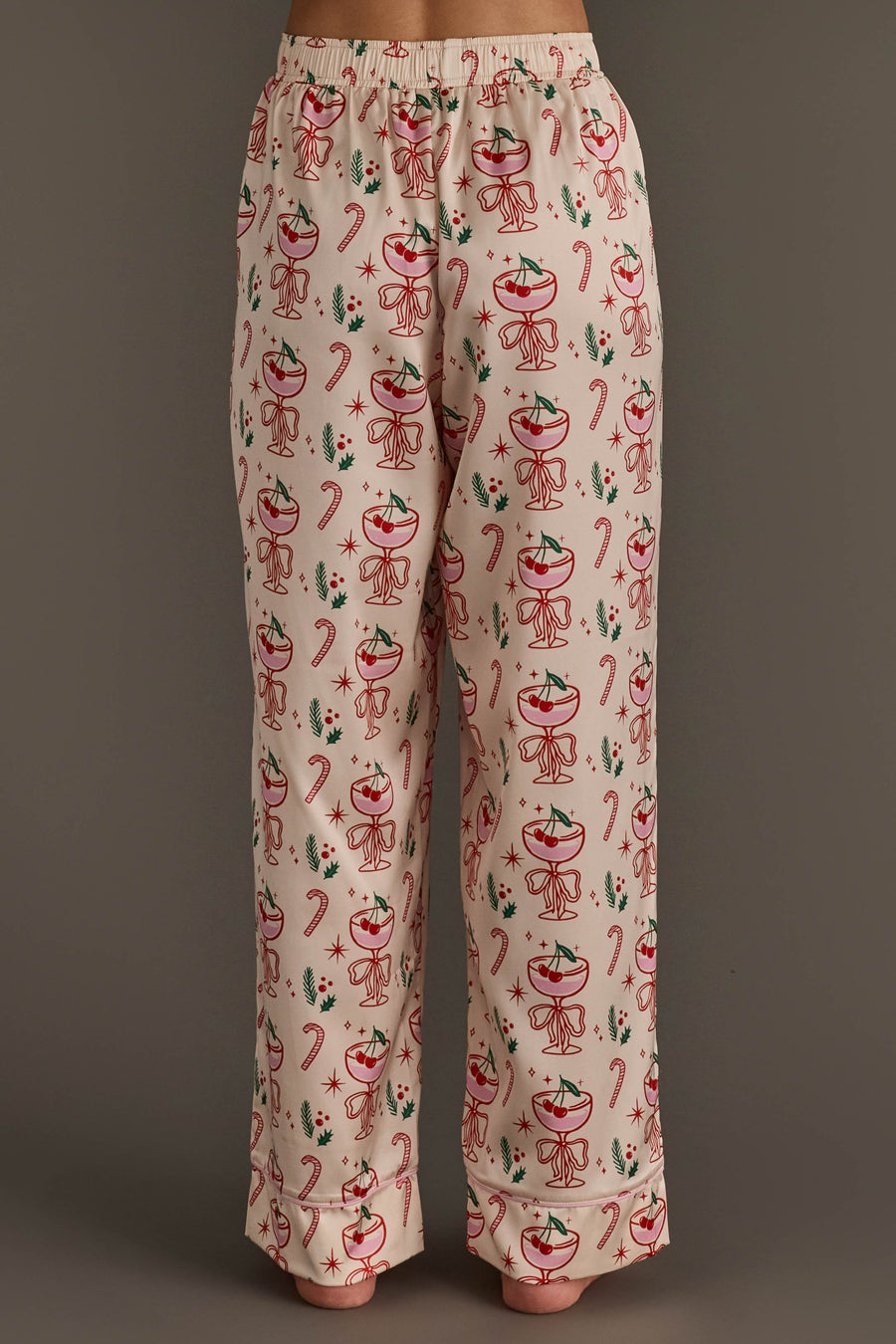 Ivory Christmas Cocktails Satin Pajama Set featuring cream-colored pajama pants with a festive print of cocktails, candy canes, and holly sprigs for holiday lounging.