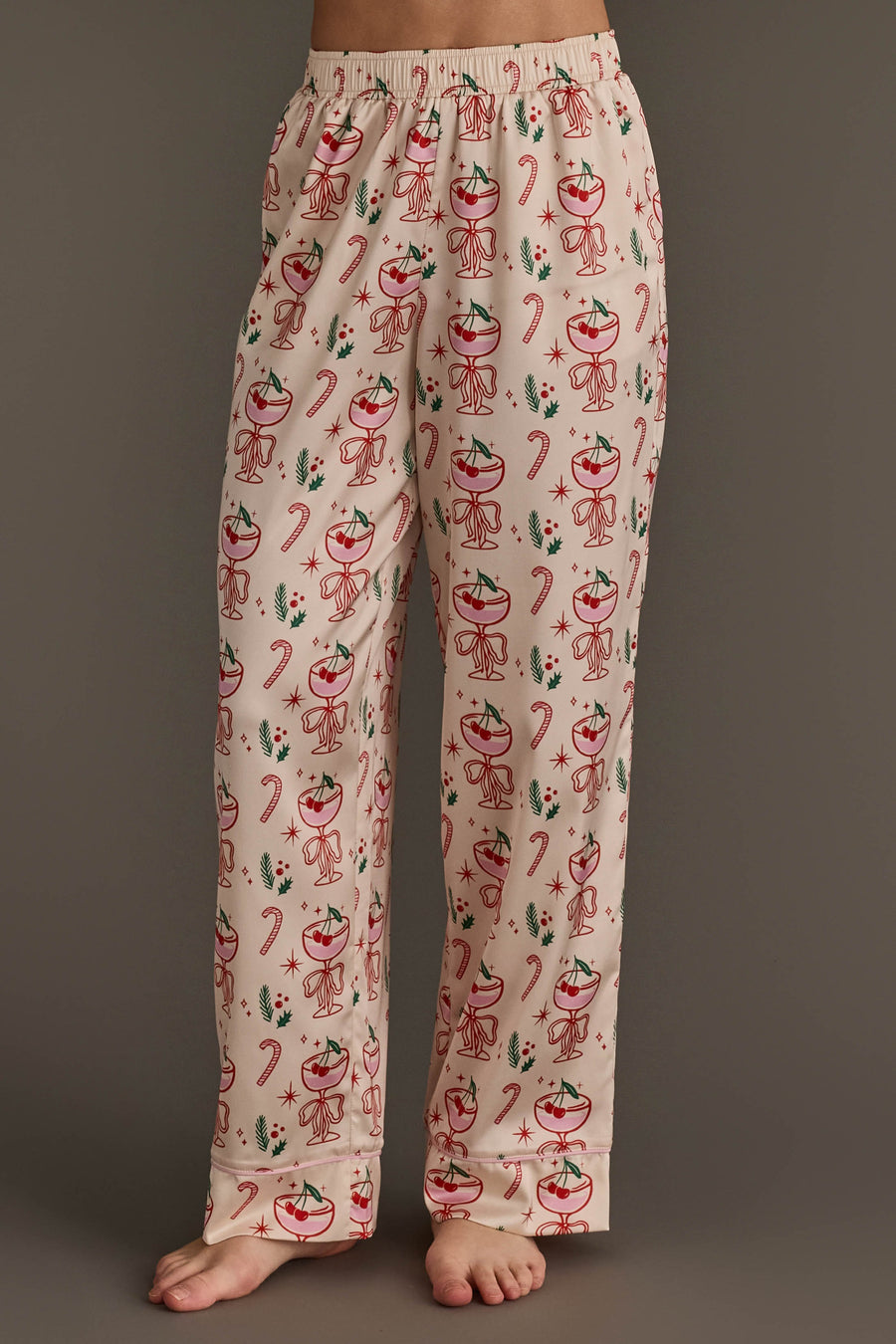 Ivory Christmas Cocktails Satin Pajama Set featuring light-colored pajama pants with a festive cocktail print of glasses, candy canes, and greenery, perfect for holiday lounging.