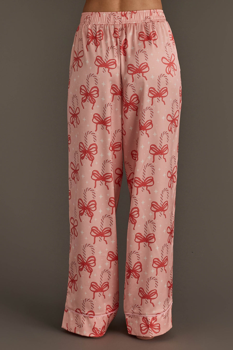 Light pink satin pajama pants from the Candy Canes & Bows Satin Pajama Set, featuring a red candy cane and bow print.