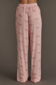 Light pink pajama pants from the Christmas Cocktails Jersey Pajama Set featuring a repeating pattern of holiday cocktails.