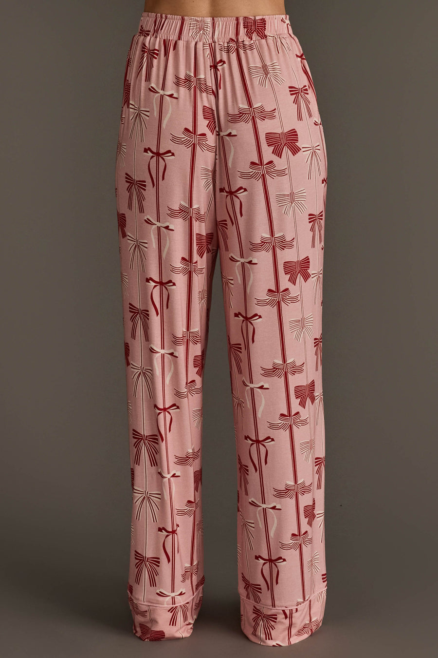 Bows Jersey Pajama Set pale pink jersey pajama pants with a festive red bow print and an elasticized waistband.