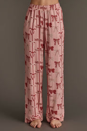 Pale pink Bows Jersey Pajama Set pants featuring a festive repeating pattern of red bows.