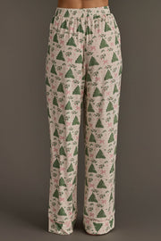 Trees & Bows Jersey Pajama Set featuring light-colored loungewear pants with a repeating pattern of green Christmas trees, pink bows, and holly sprigs.