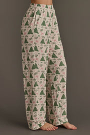 Off-white jersey pajama pants from the Trees & Bows Jersey Pajama Set, featuring a repeating pattern of green Christmas trees and pink bows, an elastic waistband, and pink piped hems.