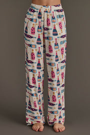 Cream-colored Champagne Bottles Jersey Pajama Set pants featuring an all-over print of champagne bottles and gold stars.