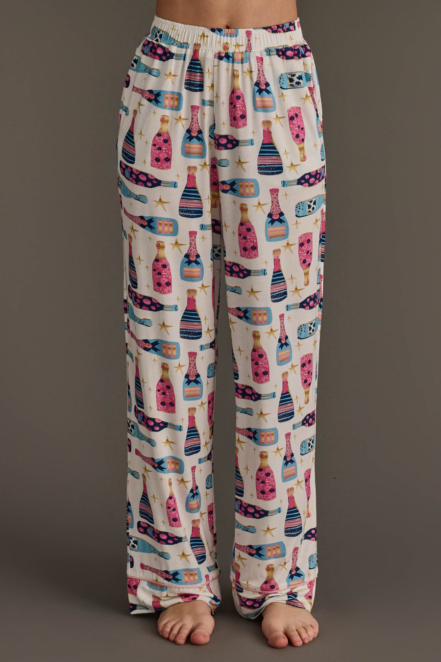 Cream-colored Champagne Bottles Jersey Pajama Set pants featuring an all-over print of champagne bottles and gold stars.