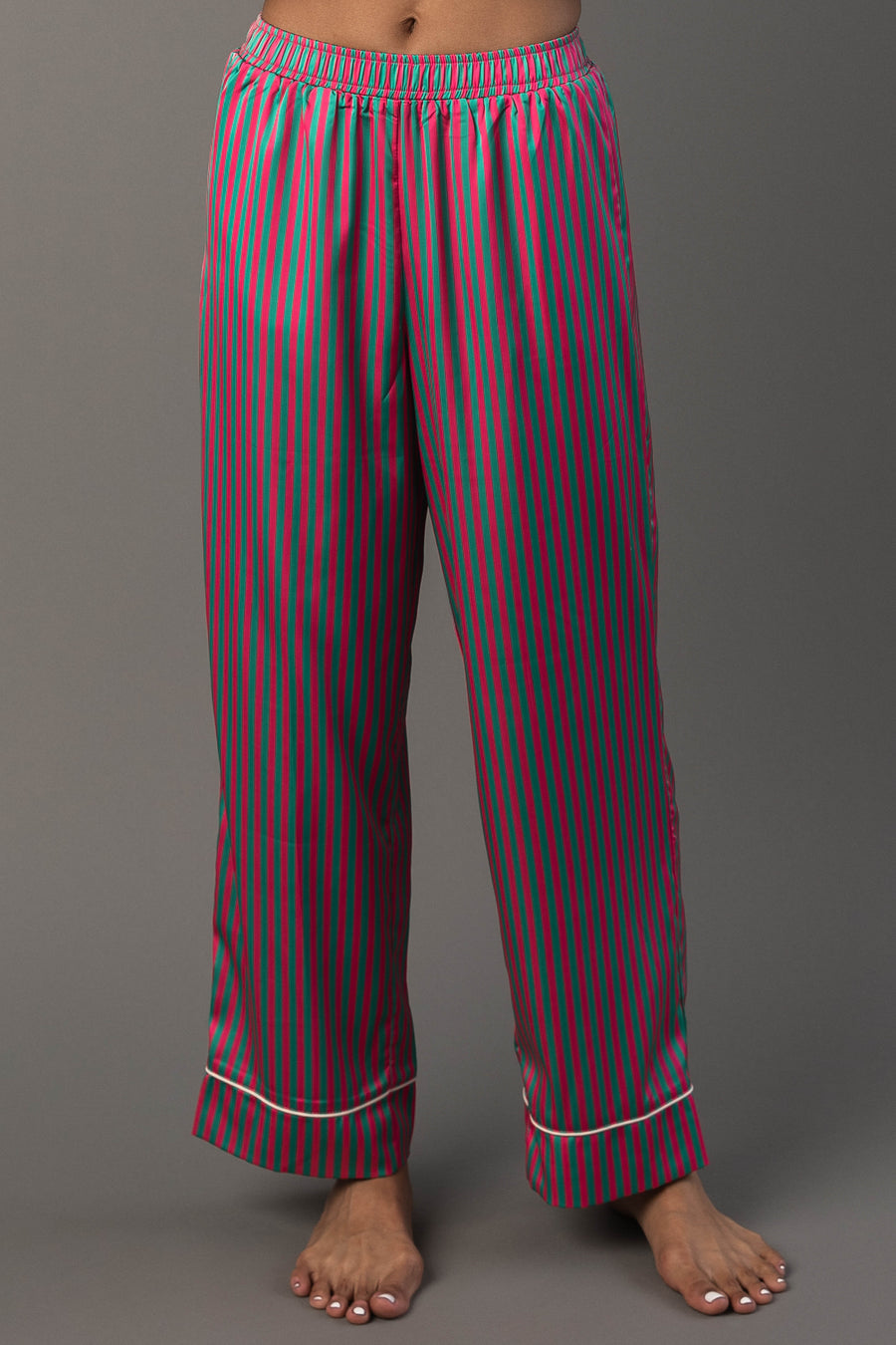 Pink & Green Striped Satin Pajama Set featuring satin pajama pants with pink and green vertical stripes, an elastic waistband, and white trim at the hems.