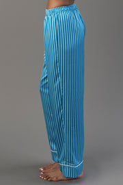Side view of Blue & Light Blue Striped Satin Pajama Set pants, featuring blue and light blue stripes, a drawstring waist, and white piped cuffs.
