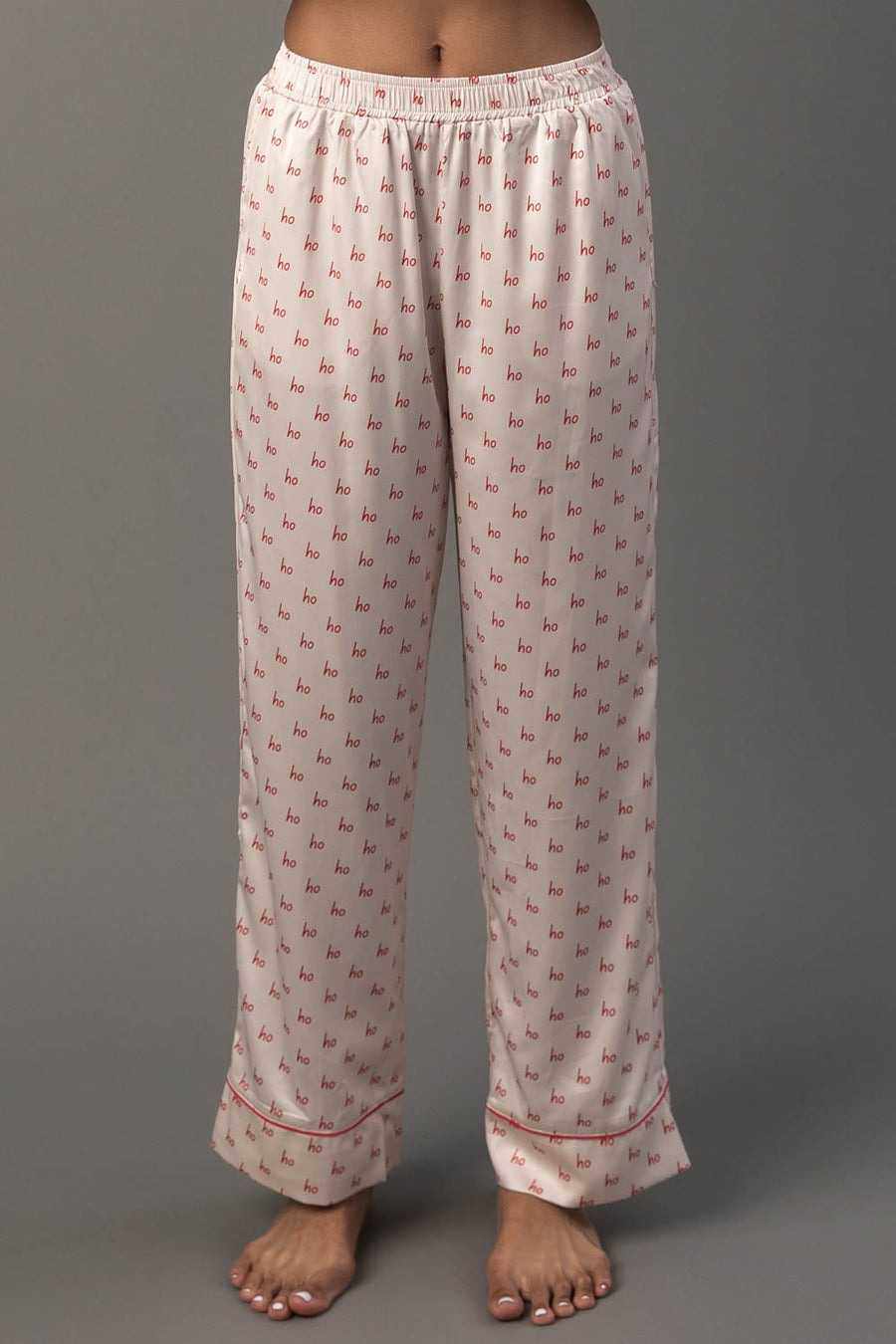 Ivory & Red Ho Ho Ho Satin Pajama Set pants in ivory satin with a red ho pattern and red hem trim.