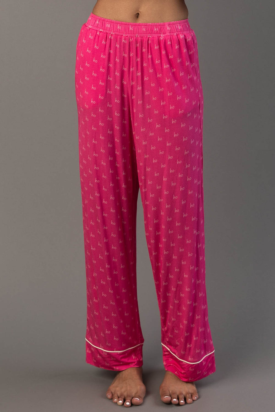 Pink & Light Pink Ho Ho Ho Jersey Pajama Set bright pink pajama pants with a repeating ho pattern and white piping at the ankles.