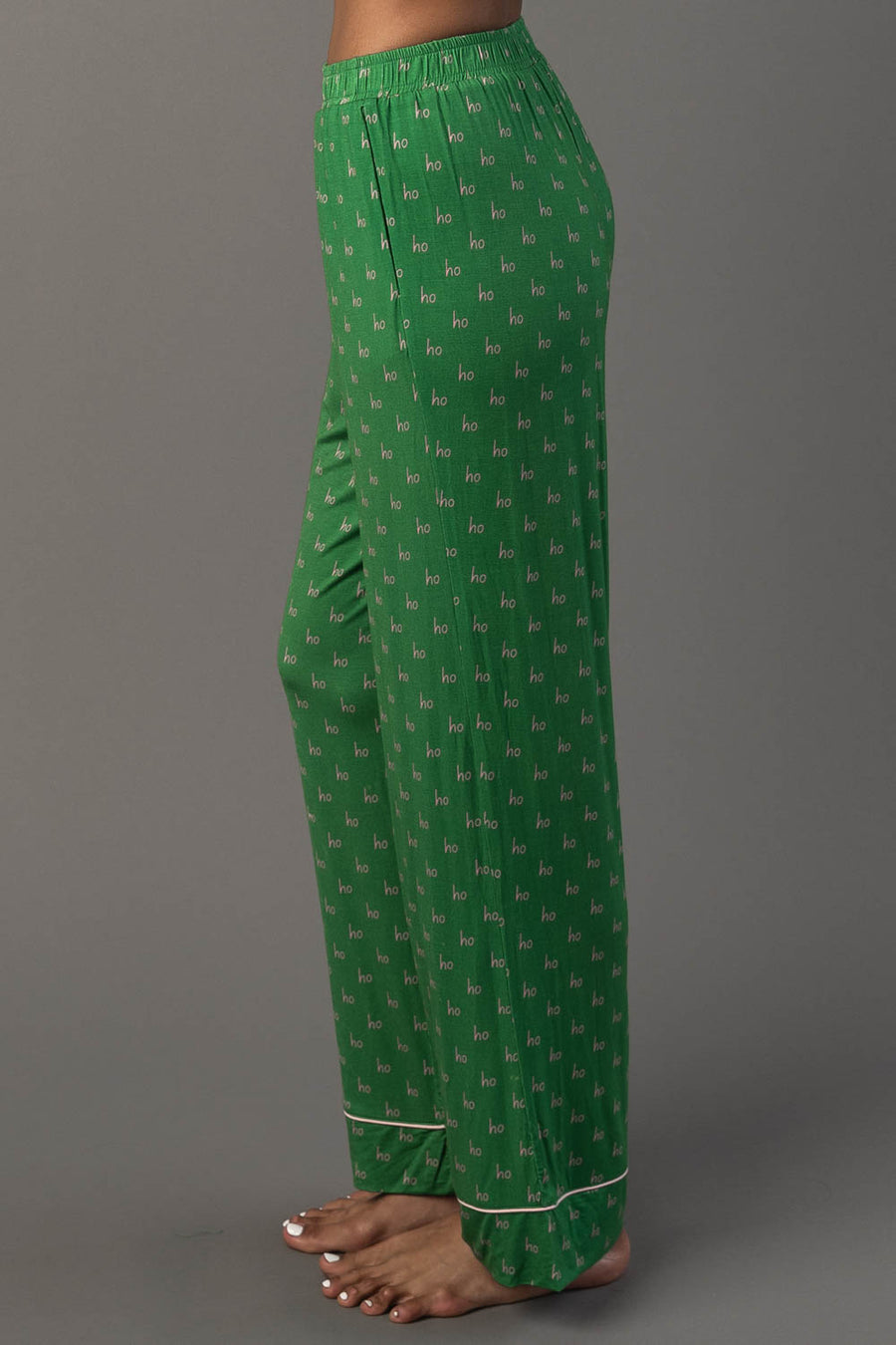 Green & Light Pink Ho Ho Ho Jersey Pajama Set pants with a repeating light pink print and light pink trim at the ankles.