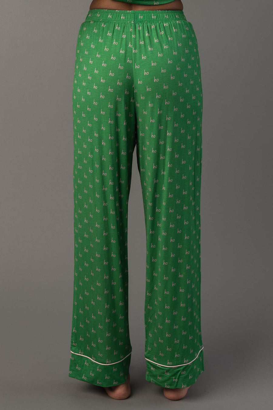Green & Light Pink Ho Ho Ho Jersey Pajama Set featuring green jersey pajama pants with a repeating light pink Ho Ho Ho print and light pink piping at the cuffs.