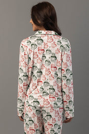 Back view of a person wearing an Ivory Santa Mugs Jersey Pajama Set in white, featuring a repeating print of Santa Claus and candy canes.