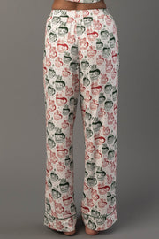 Pajama pants from the Ivory Santa Mugs Jersey Pajama Set featuring a repeating pattern of red and green Santa Claus mugs.