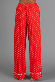 Red & White Ho Ho Ho Jersey Pajama Set featuring red jersey pajama pants with a white repeating ho print and white hem piping.