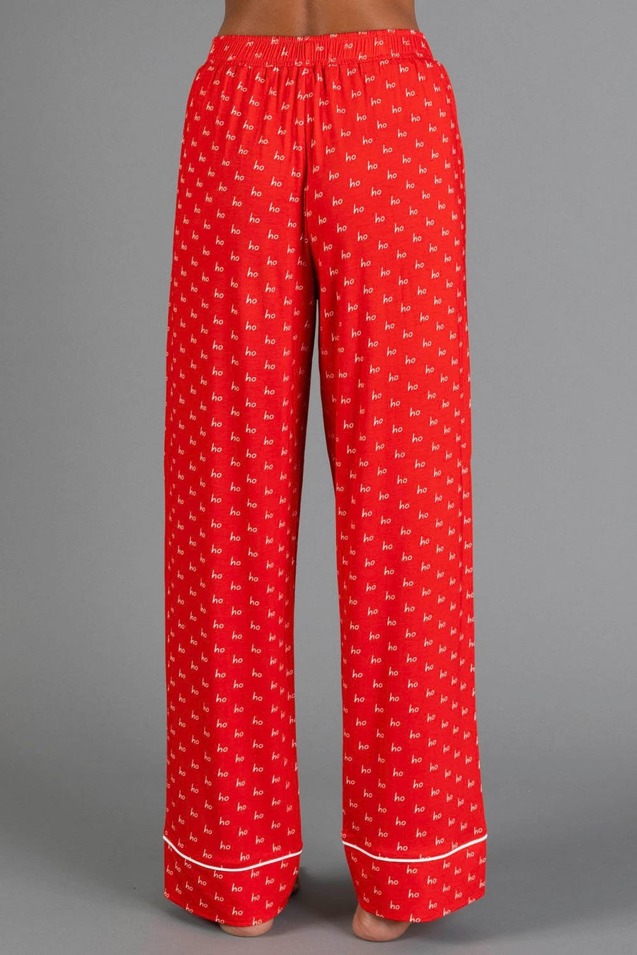 Red & White Ho Ho Ho Jersey Pajama Set featuring red jersey pajama pants with a white repeating ho print and white hem piping.