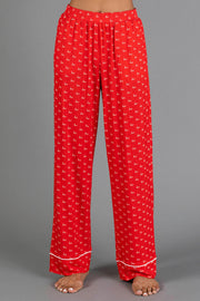 Red & White Ho Ho Ho Jersey Pajama Set featuring red holiday pajama pants with an all-over white ho ho ho print and white hem trim.