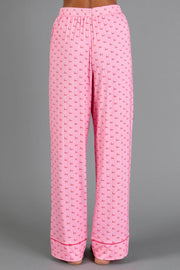 Light Pink & Red Ho Ho Ho Jersey Pajama Set featuring light pink holiday pajama pants with an all-over print of the words ho ho ho in red text.