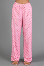 Light Pink & Red Ho Ho Ho Jersey Pajama Set pants in light pink jersey featuring a repeating red ho ho ho print and red piping at the cuffs.