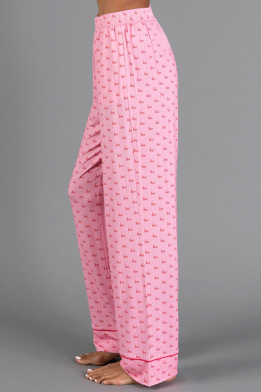Light pink and red Ho Ho Ho Jersey Pajama Set pajama pants featuring a repeating red ho ho ho print.