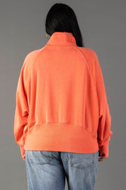 A person with long dark hair is seen from the back wearing the Panache Apparel Collection Coral Quarter Zip Sweatshirt and light blue jeans, standing against a plain gray background.