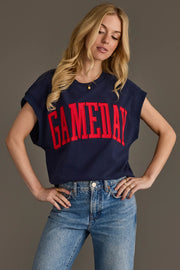 A woman models the Panache Apparel Collection’s Navy & Red Game Day Short Sleeve Sweatshirt, featuring bold red "GAMEDAY" lettering, styled with light blue jeans and posing with her hands on her hips against a neutral backdrop.