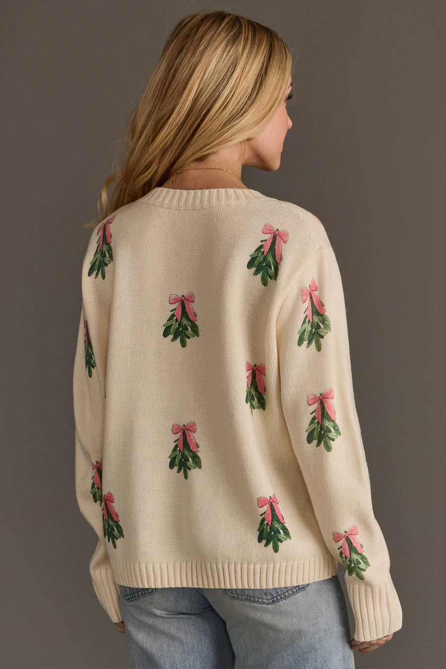 Ivory Tree Sweater with Pink Bows in cream-colored knit featuring a repeating pattern of green mistletoe sprigs with pink bows.