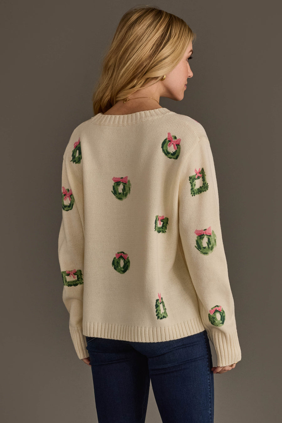 Ivory Wreath Sweater with Pink Bows in cream, featuring a pattern of small green wreaths tied with pink bows on a long-sleeve silhouette.