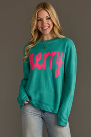 A woman wearing a Light Blue & Bright Pink Merry Sweater, featuring a teal crewneck with the word merry in bright pink script across the front.