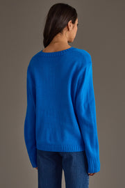 A person wearing the Royal Blue & Light Blue Merry Sweater, a royal blue long-sleeved sweater with light blue trim around the neckline and cuffs.