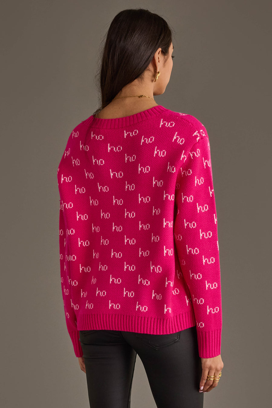 A person wearing a Panache Apparel Collection Bright Pink & Light Pink Ho Ho Ho Sweater with a repeating white ho ho ho pattern.