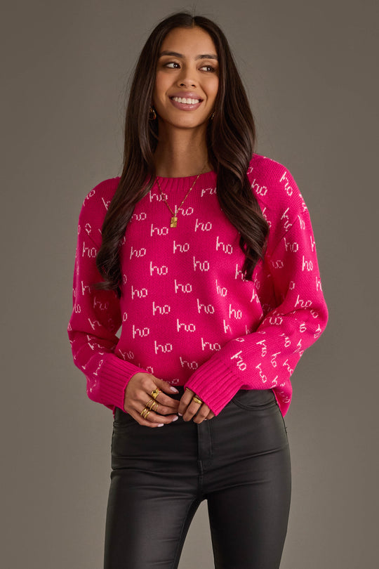 A bright pink long-sleeved Bright Pink & Light Pink Ho Ho Ho Sweater patterned with the word ho in light pink.