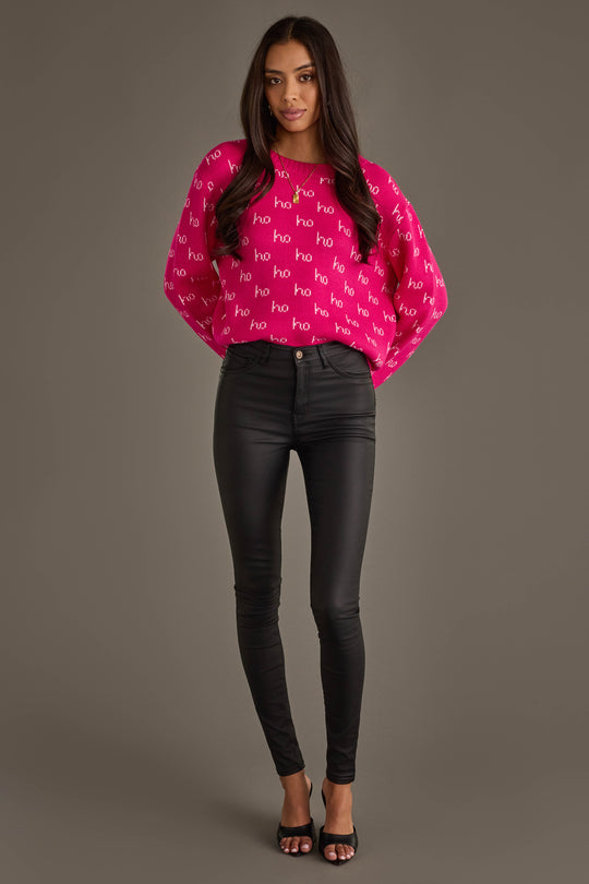 A person wearing a Bright Pink & Light Pink Ho Ho Ho Sweater, black skinny pants, and black heeled sandals.