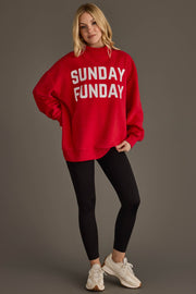 A person wearing the Panache Apparel Collection Red Game Day & Sunday Funday Reversible Sweatshirt, paired with black leggings and white sneakers, stands against a plain background, smiling slightly with one hand in their pocket.
