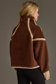 A person stands facing away against a plain background, wearing the Panache Apparel Collection Brown & Tan Half Zip Sherpa Fleece Sweatshirt paired with black leggings.