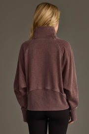 Back view of woman wearing Panache Apparel’s reddish-brown quarter zip sweatshirt.