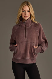 Woman wearing Panache Apparel’s reddish-brown quarter zip sweatshirt.