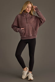 Full-length view of woman wearing Panache Apparel’s reddish-brown quarter zip sweatshirt.