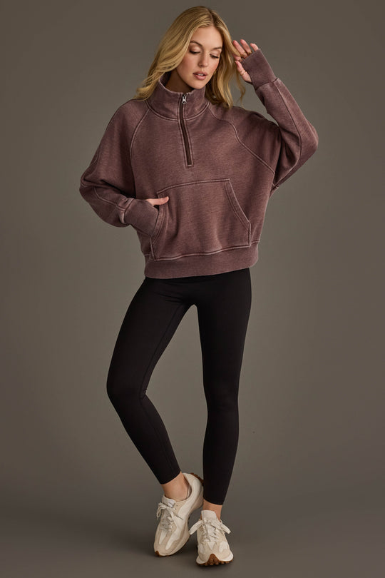 Full-length view of woman wearing Panache Apparel’s reddish-brown quarter zip sweatshirt.