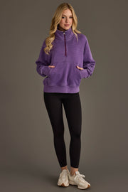 Full-length view of woman wearing Panache Apparel’s dark purple quarter zip sweatshirt.