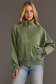 Woman wearing Panache Apparel’s sage quarter zip sweatshirt.