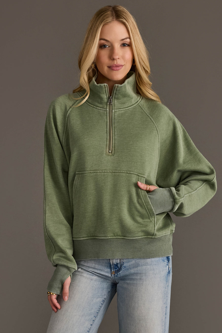 Woman wearing Panache Apparel’s sage quarter zip sweatshirt.