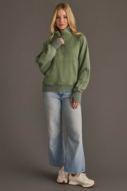 Full-length view of woman wearing Panache Apparel’s sage quarter zip sweatshirt.