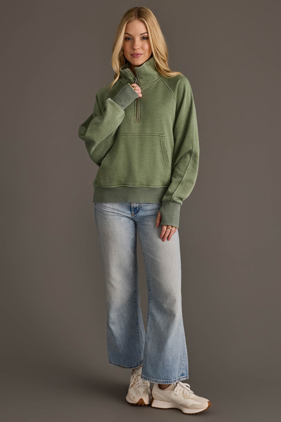 Full-length view of woman wearing Panache Apparel’s sage quarter zip sweatshirt.