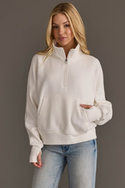 Woman wearing Panache Apparel’s white women’s quarter zip sweatshirt.