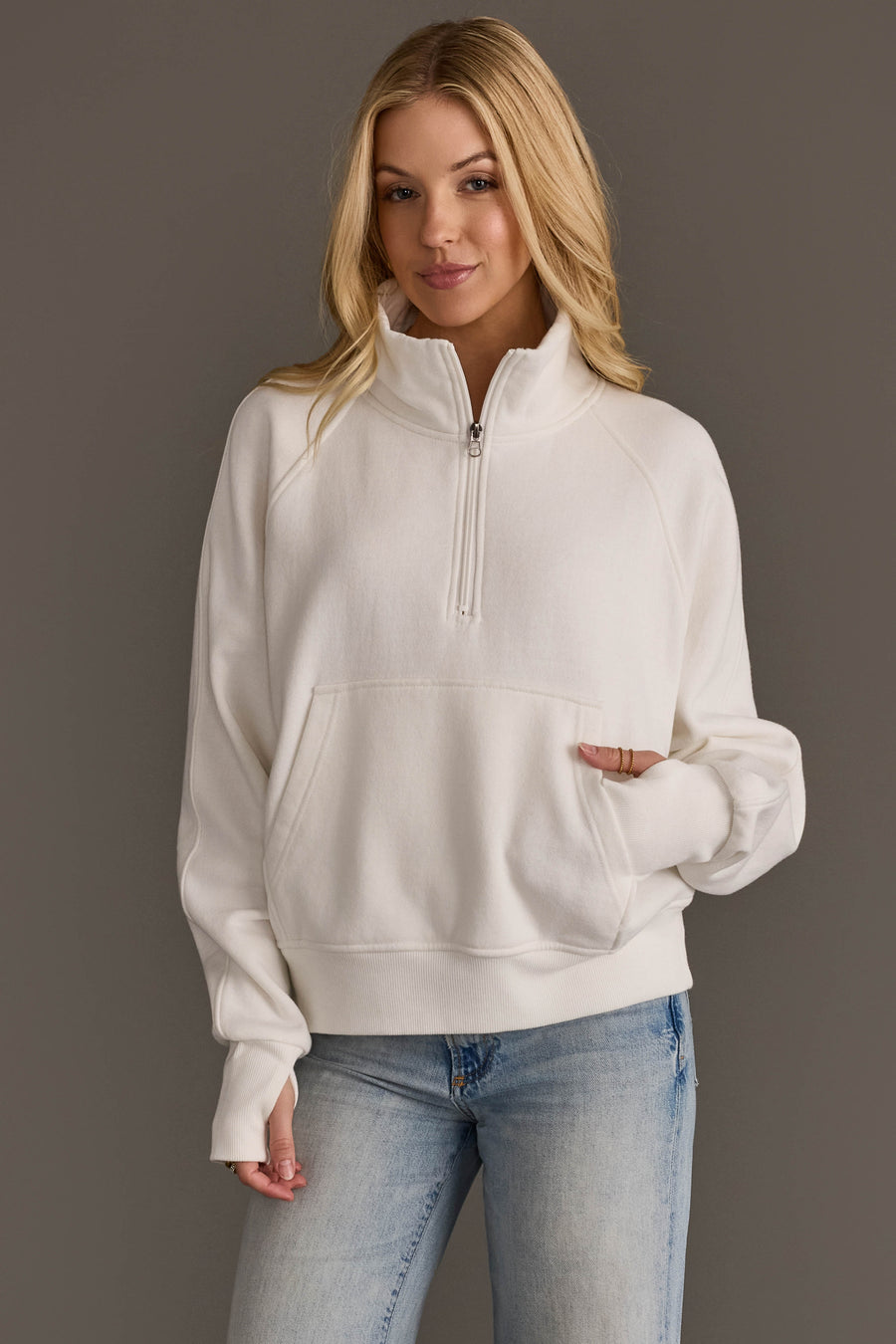 Woman wearing Panache Apparel’s white women’s quarter zip sweatshirt.