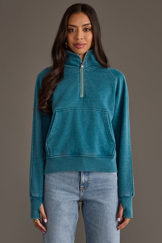 Woman wearing Panache Apparel’s dark teal women’s quarter zip sweatshirt.