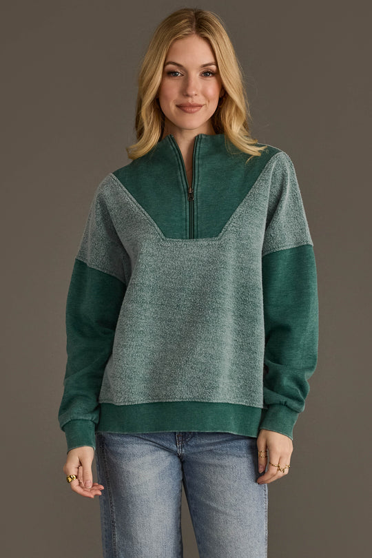 Woman wearing Panache Apparel’s teal mixed media quarter zip sweatshirt.