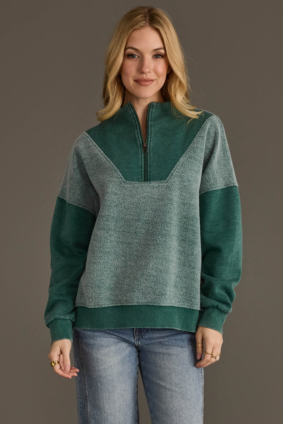 Woman wearing Panache Apparel’s teal mixed media quarter zip sweatshirt.